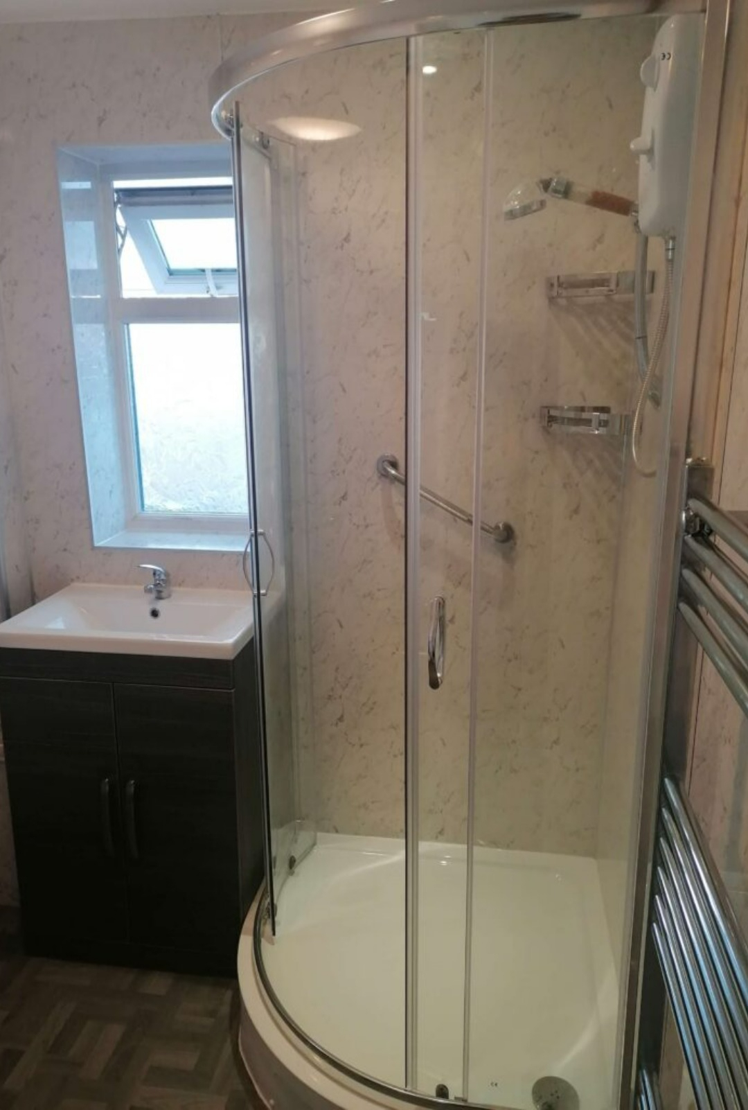 Built in basin storage with curved shower cubicle